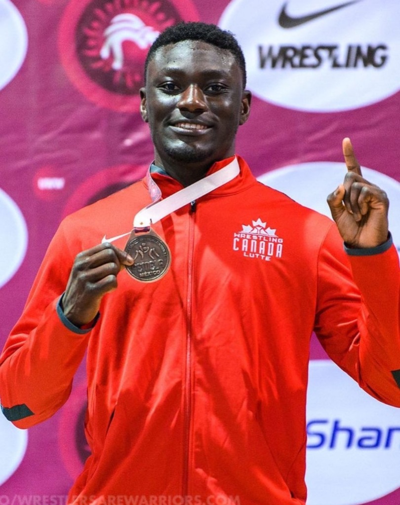 Emmanuel Olapade holding his medal from the Pan American Wrestling Championships